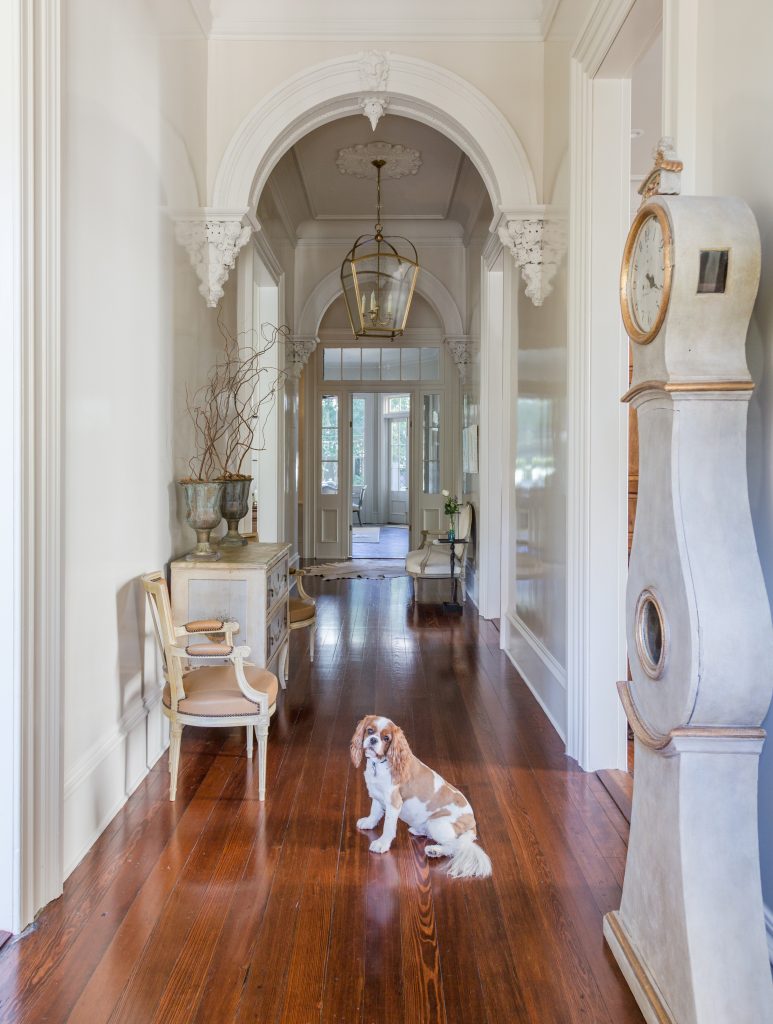 14-foot ceilings showcase coved plaster moldings and ornate archways in the large center hall. 