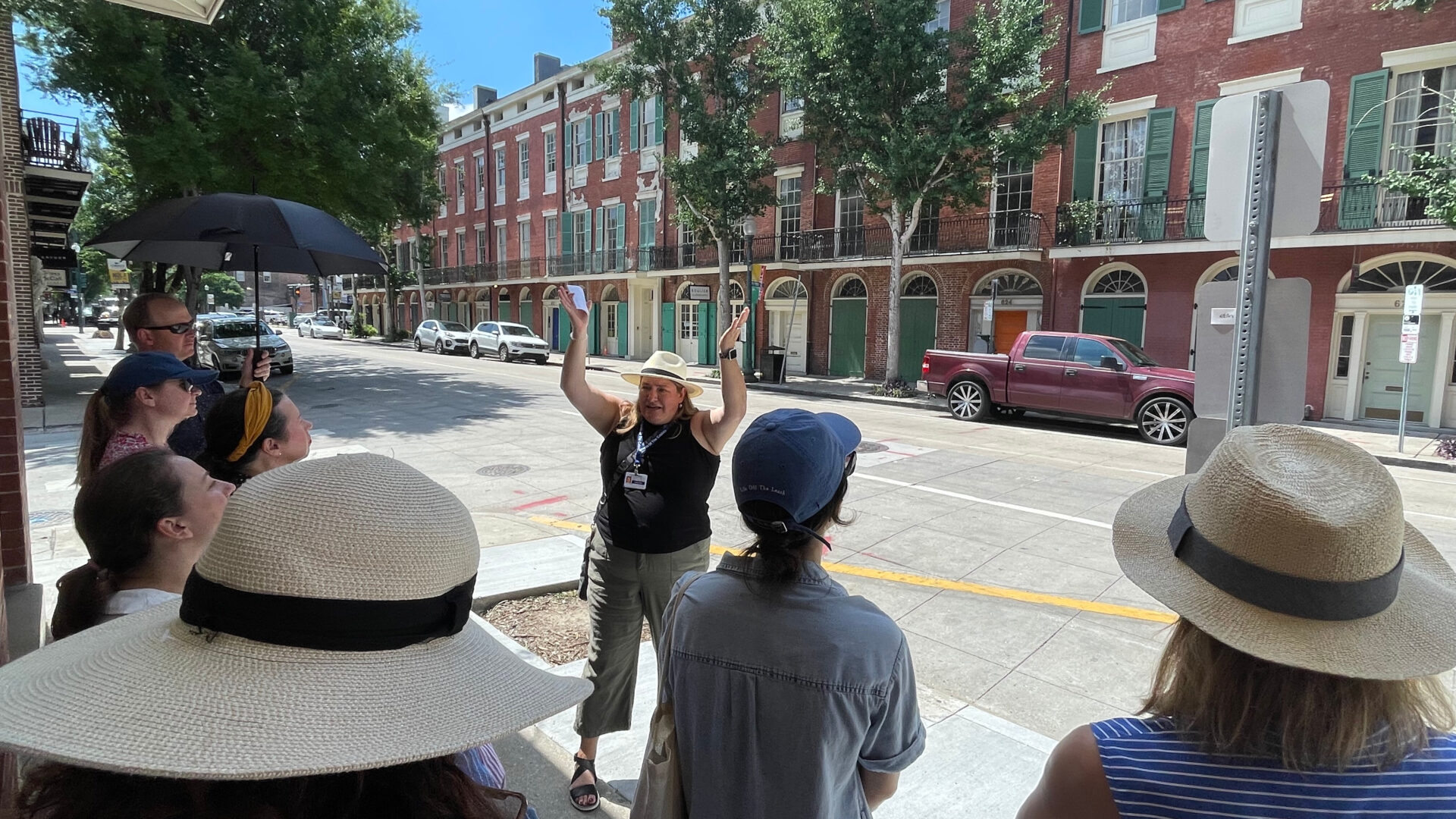 A tour guide leading a group through the Warehouse District