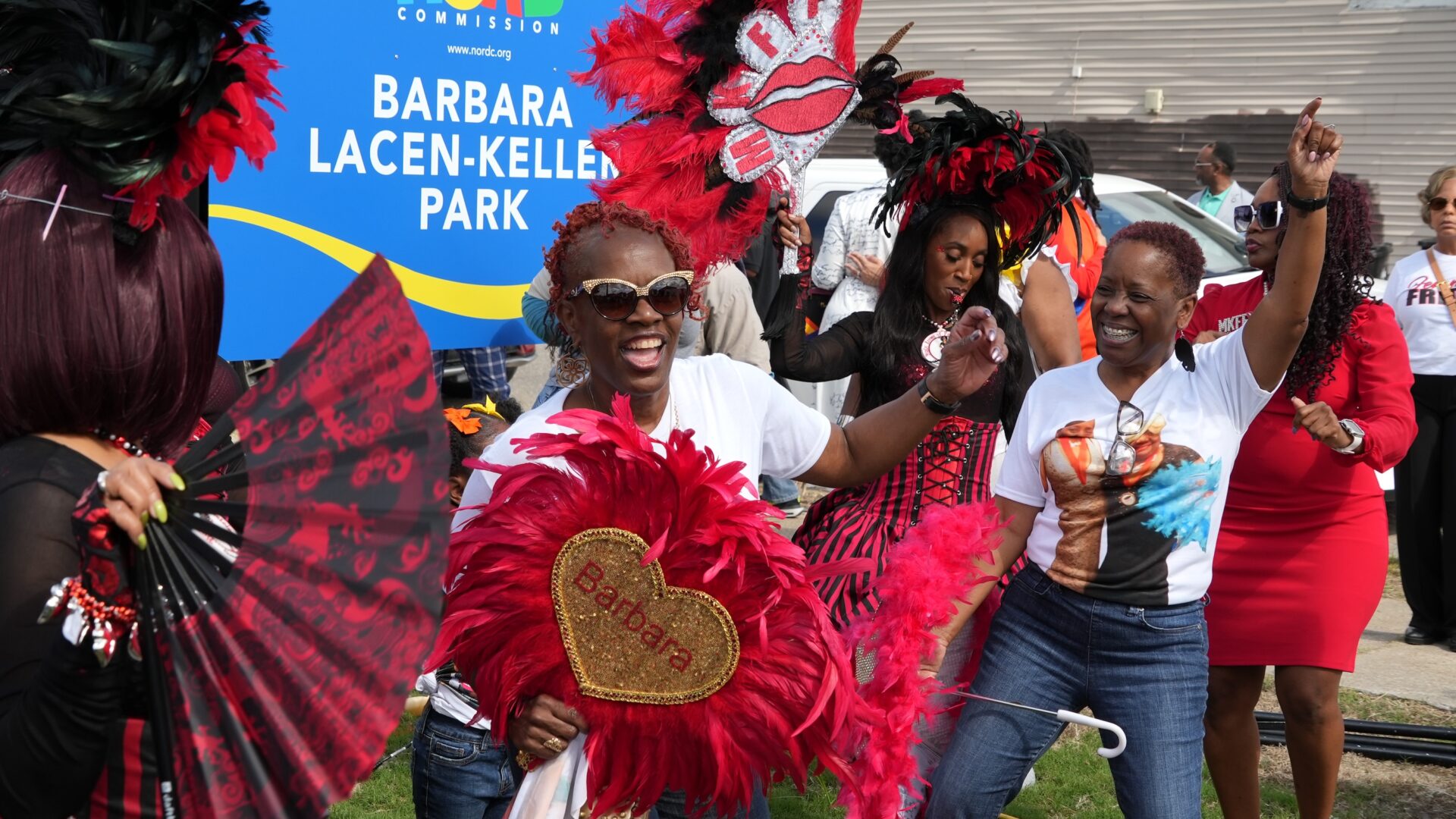 Barbara Lacen-Keller's daughters dance after the ribbon cutting for the park named in honor of their mother.
