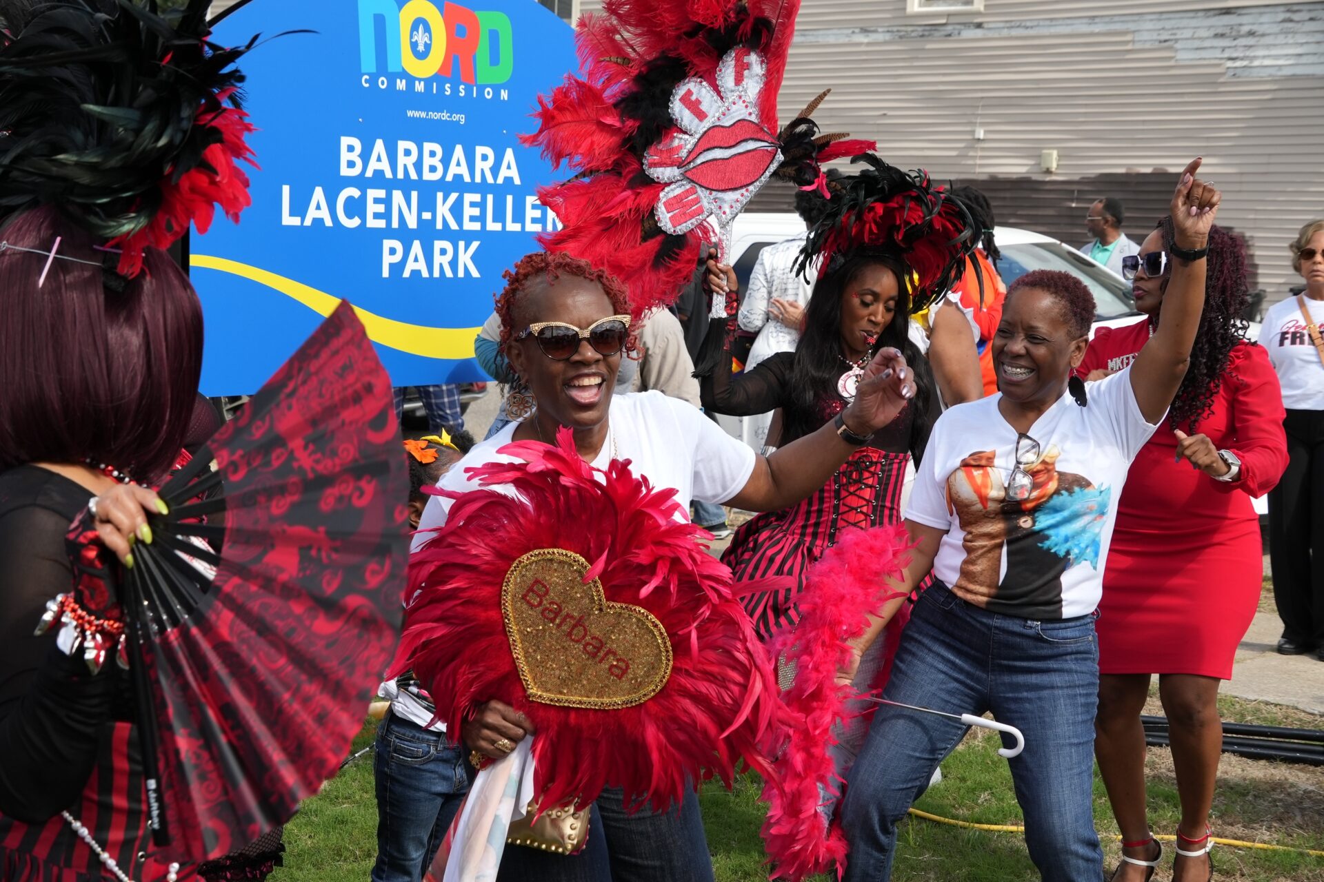 Barbara Lacen-Keller's daughters dance after the ribbon cutting for the park named in honor of their mother.