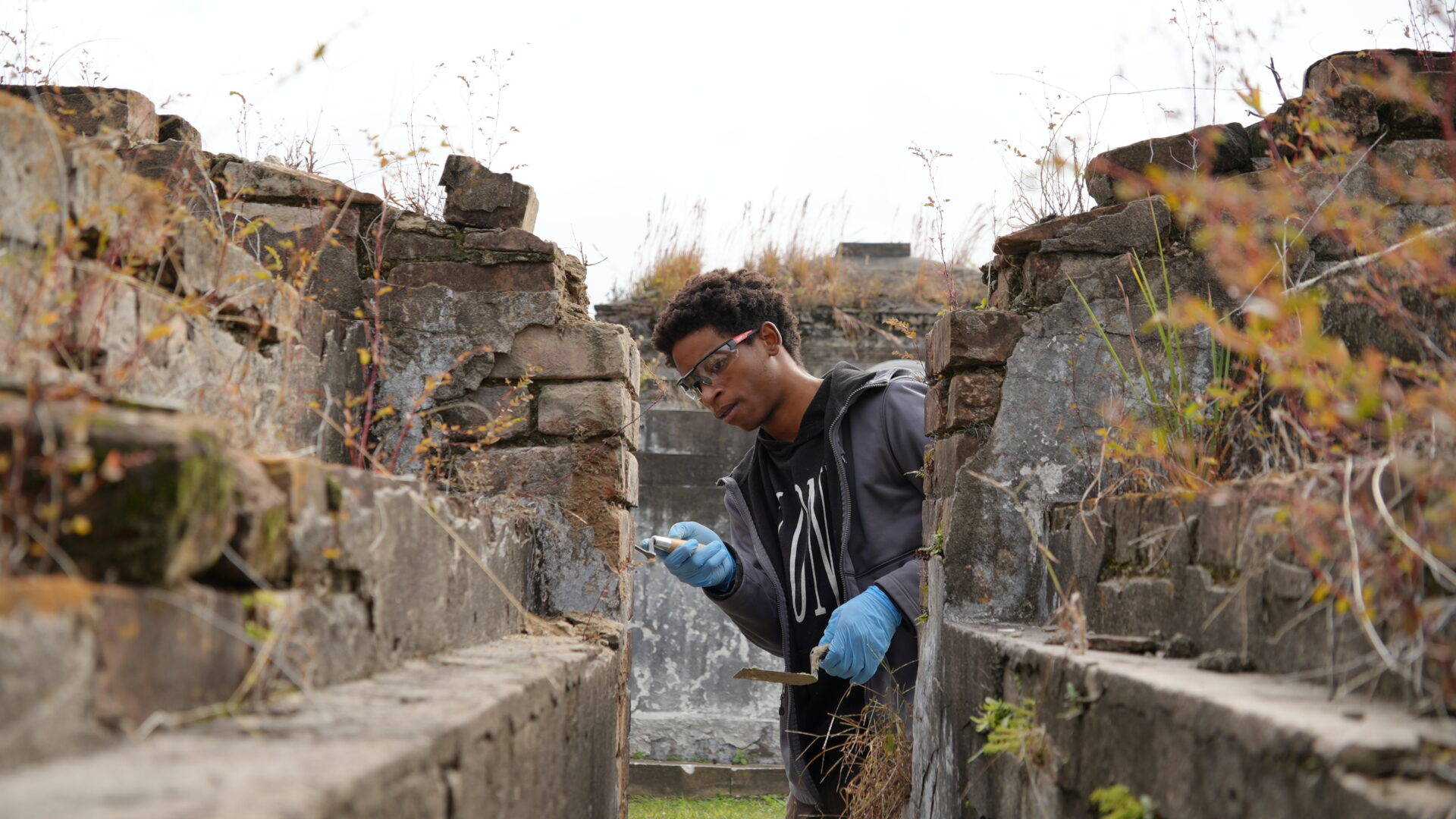 Victor McGill works on a tomb at St. Louis Cemetery No. 2 during the Bridge To Crafts Careers pilot program.