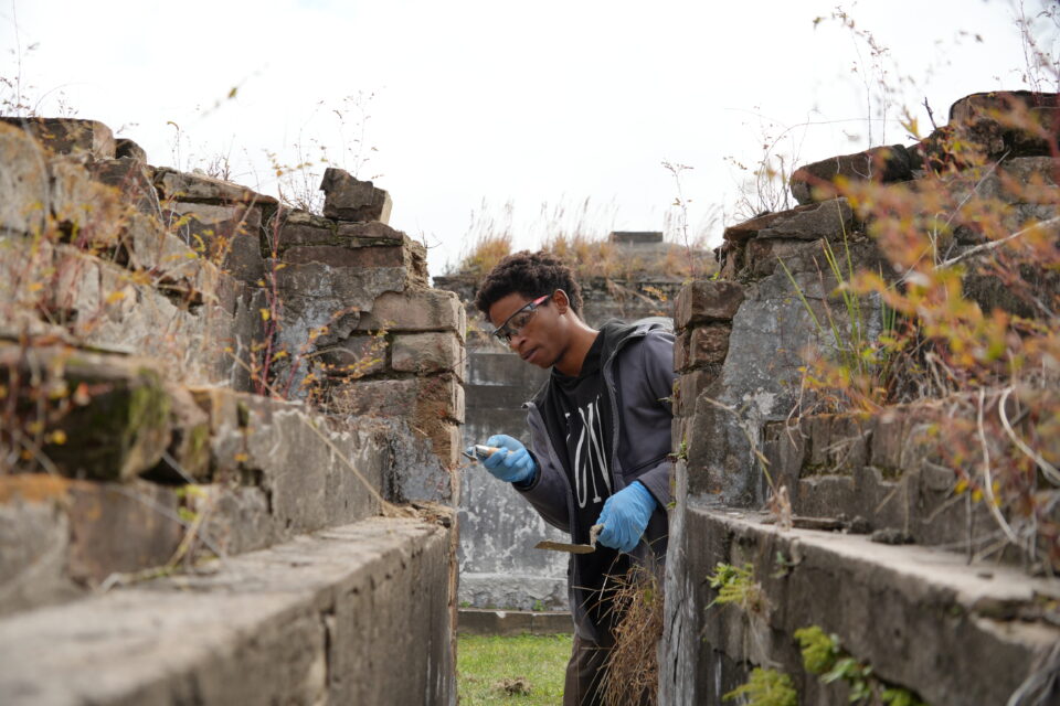 Victor McGill works on a tomb at St. Louis Cemetery No. 2 during the Bridge To Crafts Careers pilot program.