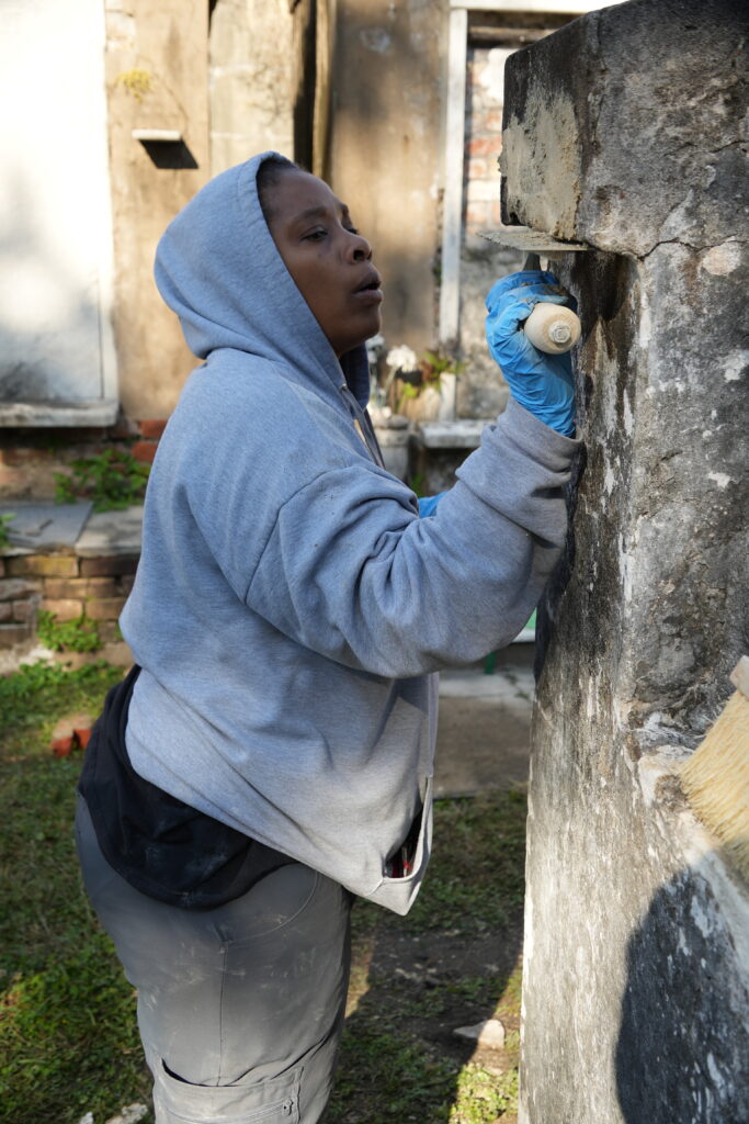 Shantel Jenkins makes repairs to a tomb in St. Louis Cemetery No. 2.
