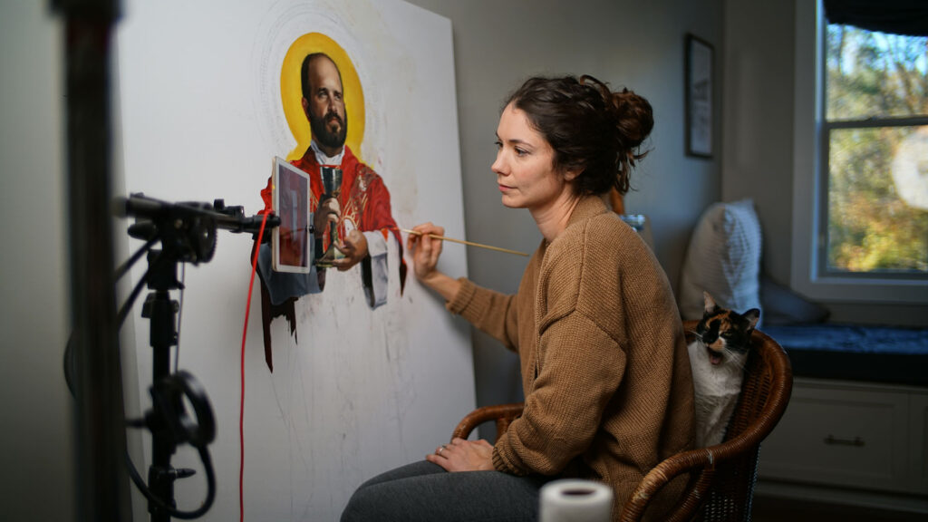 Artist Jaclyn Warren paints a portrait of one of the North American Martyrs, a group of eight Jesuit missionaries killed during the 17th Century.