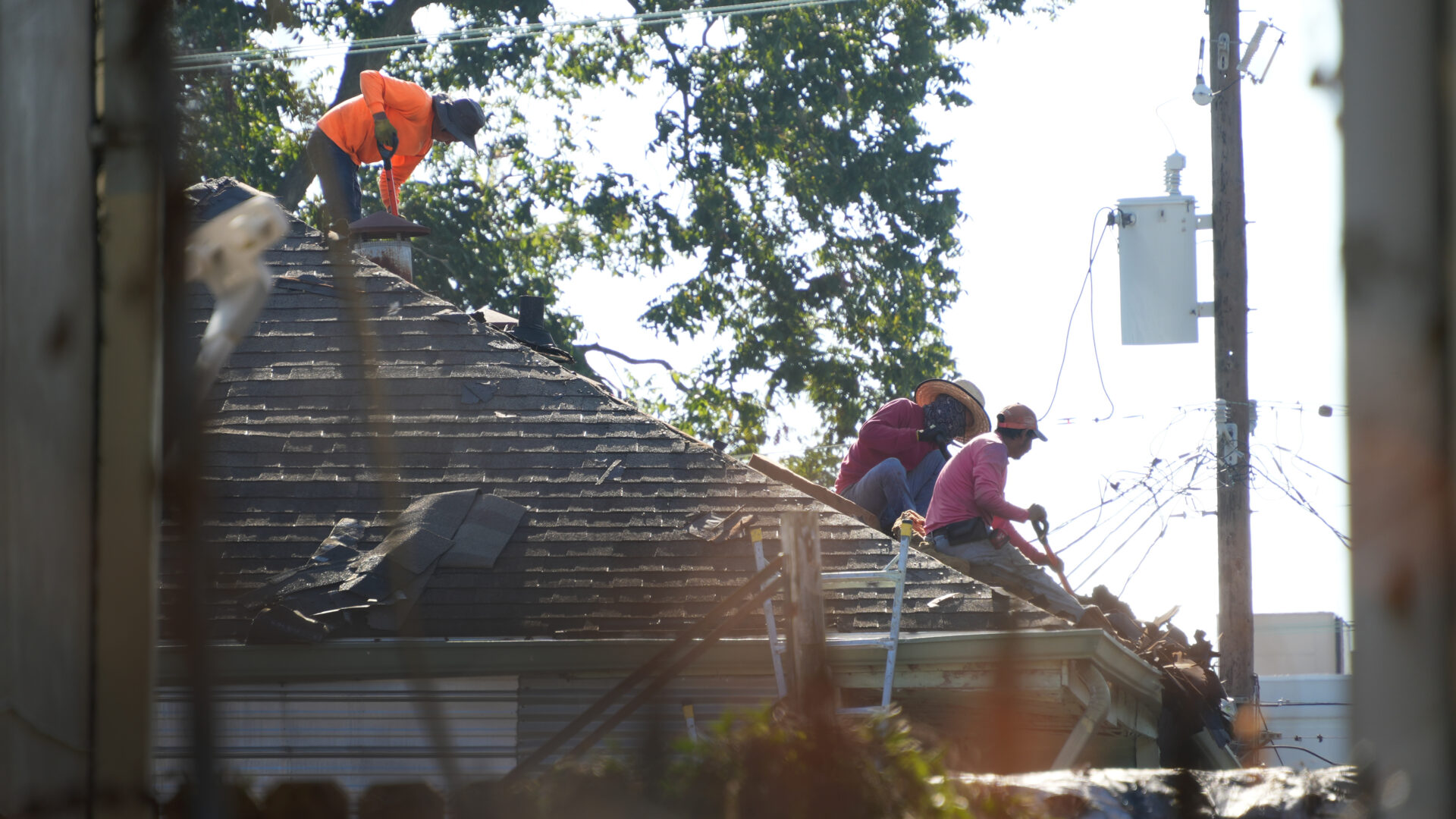 Men repairing a historic roof.