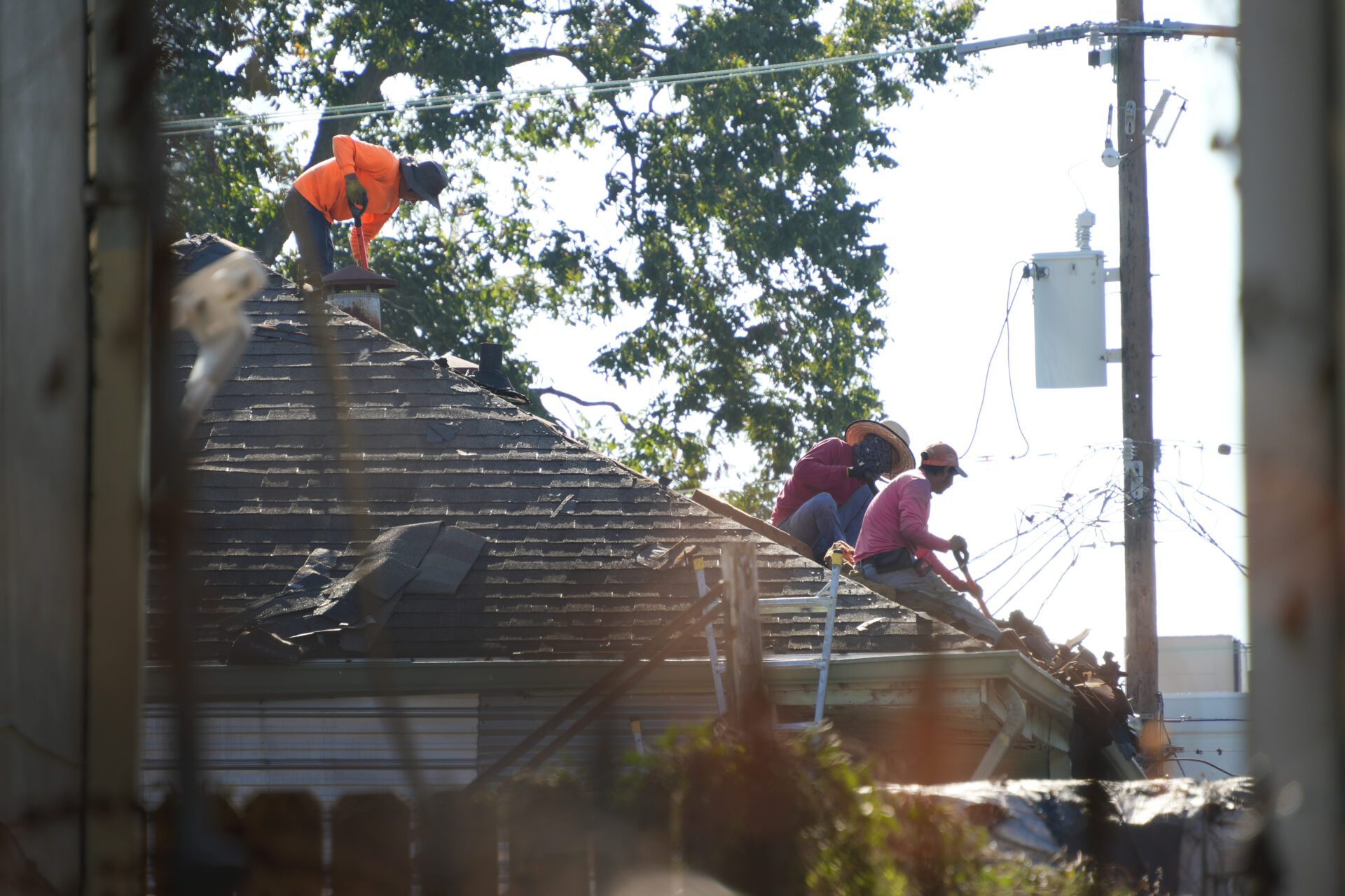 Men repairing a historic roof.