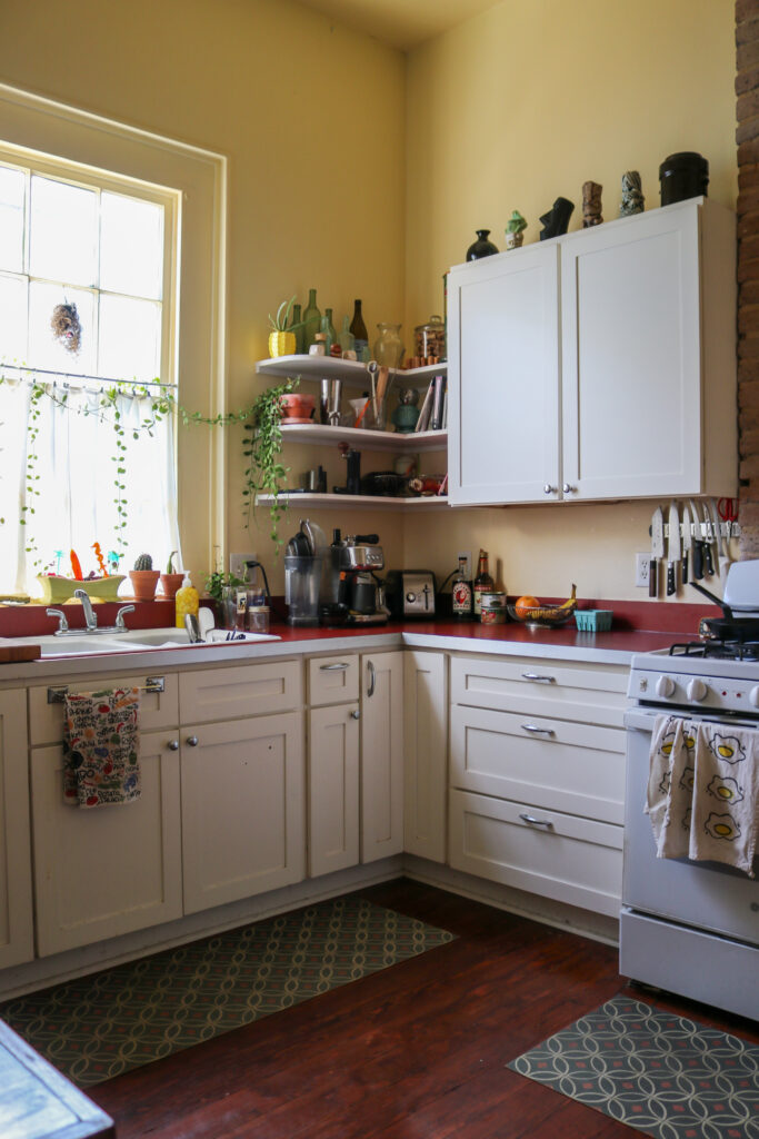 Corner shot of a New Orleans kitchen with numerous spices and ingredients on the counter.