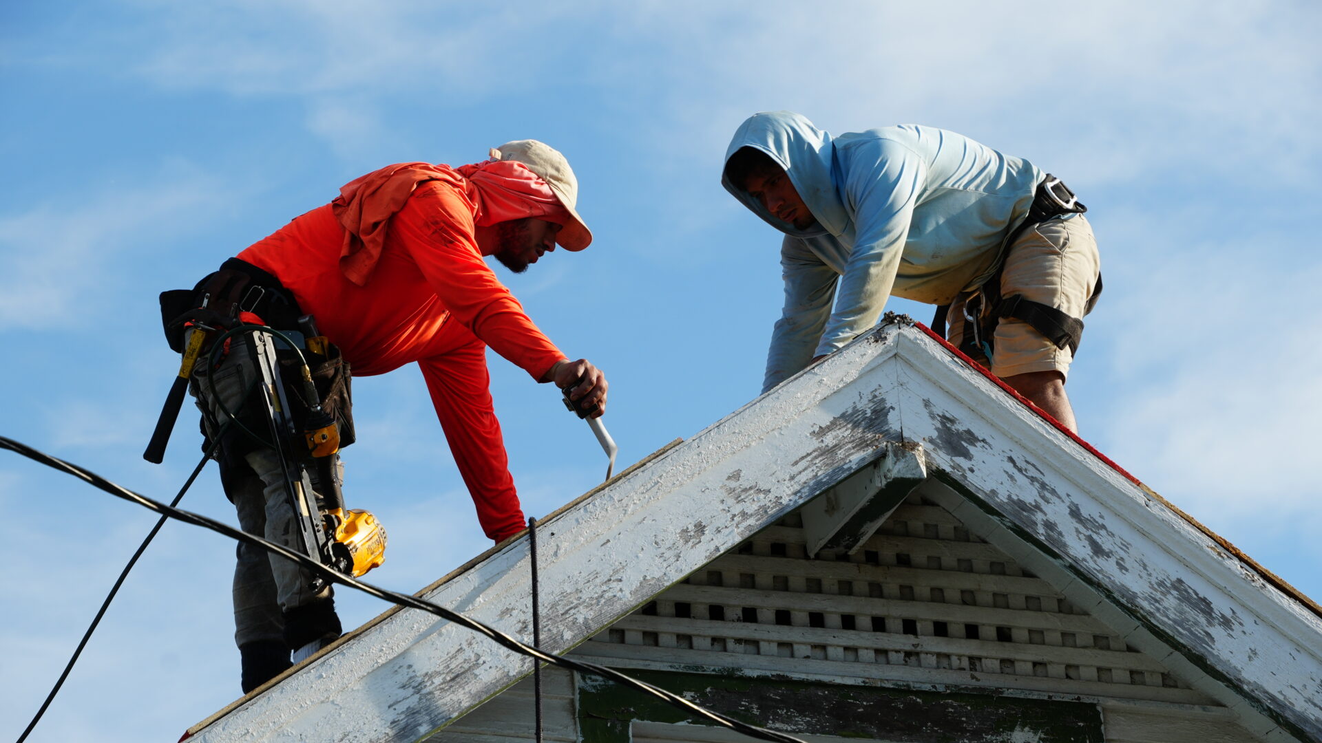 2 men work on installing a new roof in New Orleans