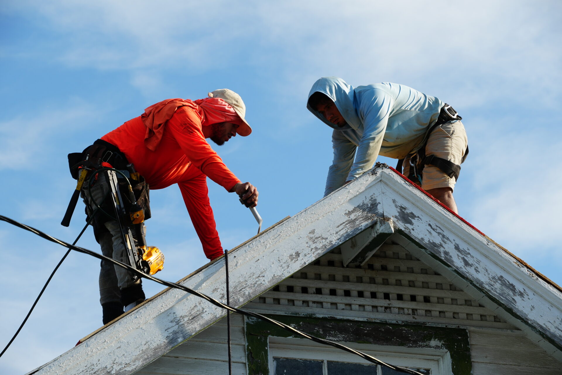 2 men work on installing a new roof in New Orleans