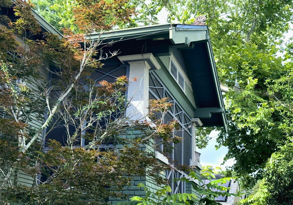 side facade of a craftman bungalow with shades of green paint