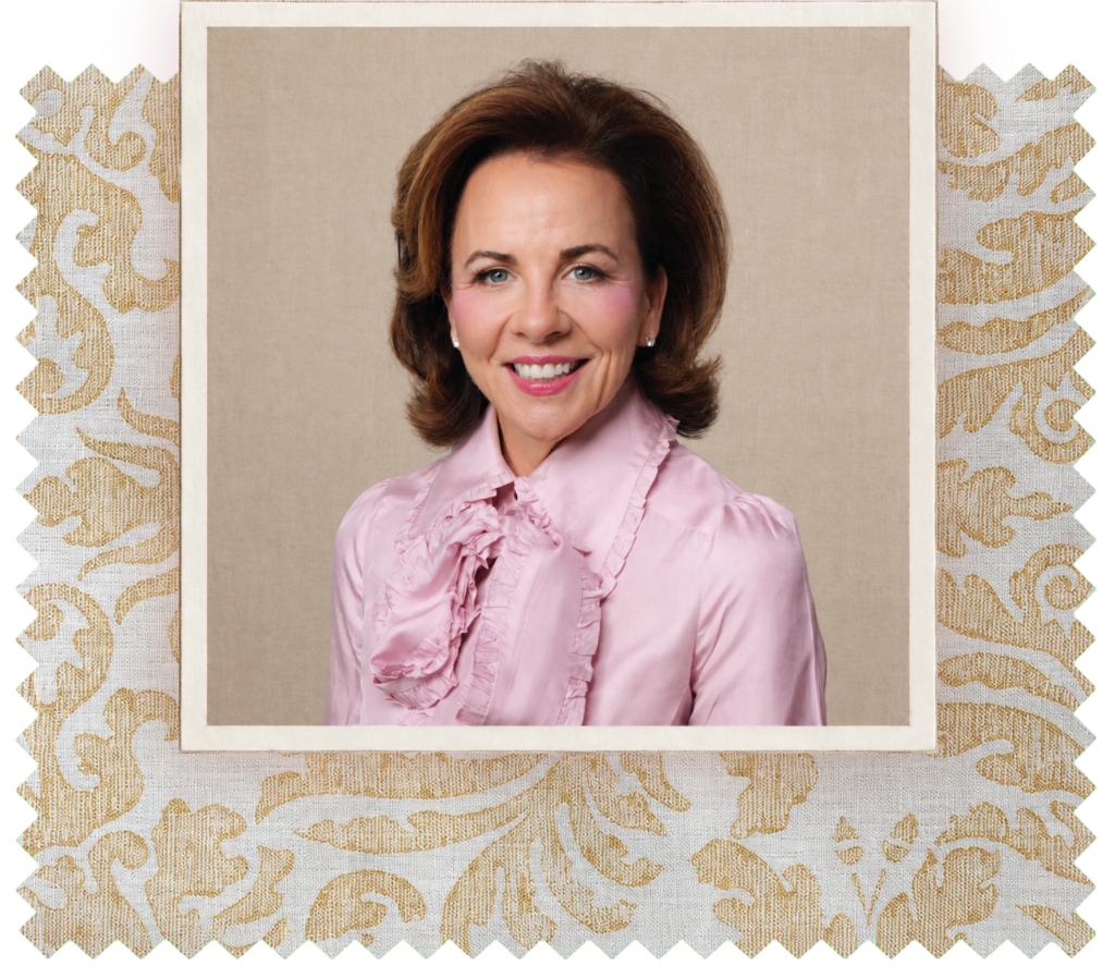 Portrait of Jane Scott Hodges, smiling and wearing a pink ruffled blouse, framed by a decorative cream-and-gold patterned border.