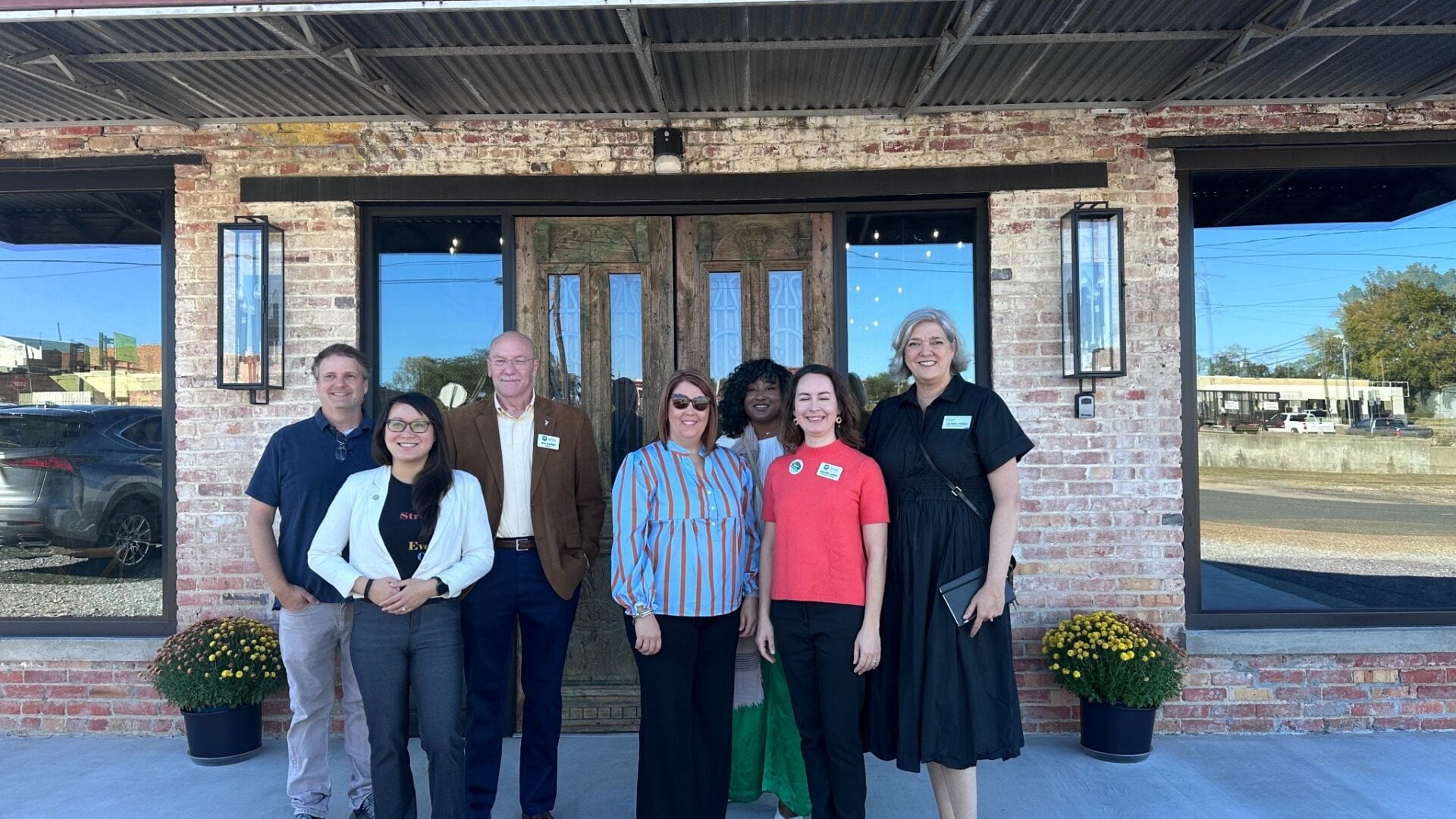 Main Street America resource team members pose outside a brick building in Winnfield, Louisiana, after completing strategic planning work in fall 2025.