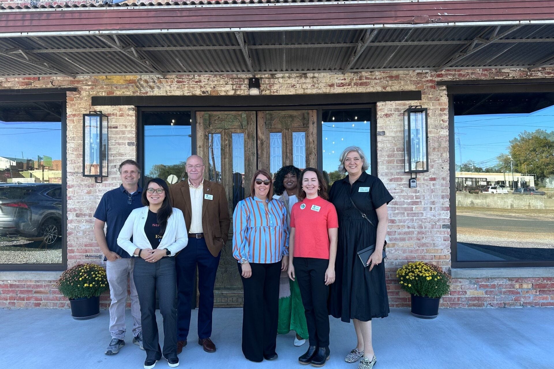Main Street America resource team members pose outside a brick building in Winnfield, Louisiana, after completing strategic planning work in fall 2025.
