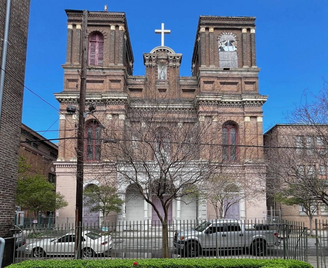 St. Alphonsus Church in New Orleans’ Irish Channel, a historic brick church with twin towers, a central cross, and ornate architectural details. Photo courtesy of NO HDLC.