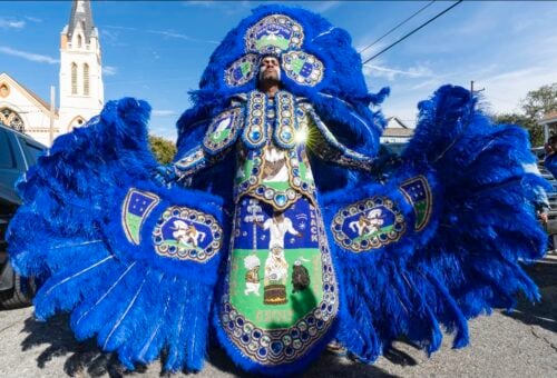 Third Chief Ghost of the Black Hawks Mardi Gras Indians in an elaborate blue feathered suit and headdress at the intersection of 2nd and Dryades streets during Mardi Gras in New Orleans, February 13, 2024.