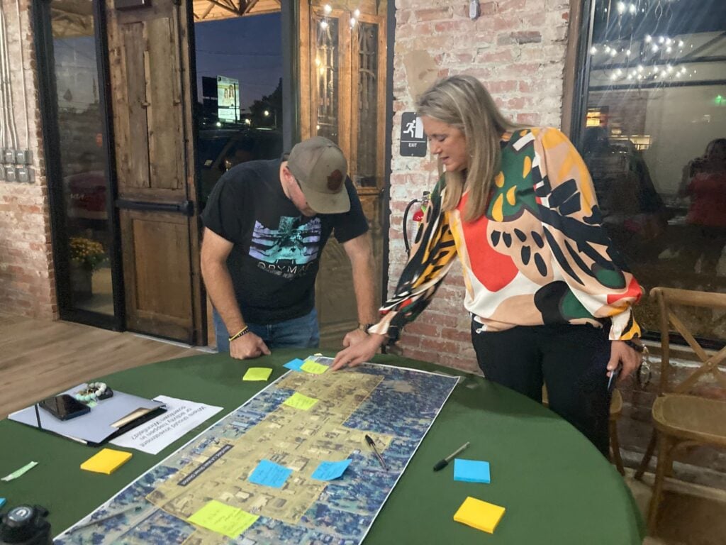 Community members review a map and add notes during a community visioning session in Winnfield, Louisiana.