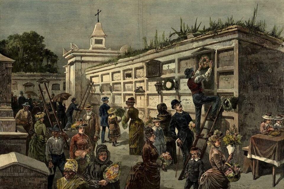 Historic illustration of All Saints’ Day in New Orleans showing people decorating above-ground cemetery tombs with flowers and wreaths. Visitors gather throughout the cemetery, with ladders leaning against the tombs as people clean and adorn the burial sites.